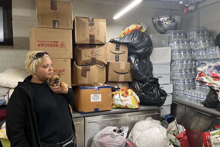 Camille Napoleon, president of the Baruch Houses Tenants’ Association, looks over the donated goods that are stored in a room in the housing complex. These supplies get donated to migrants arriving at the Port Authority and staying in city shelters.